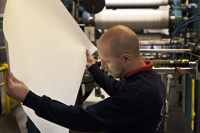 Photograph of inspecting paper at G F Smith.