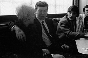 Black and white photograph of trawlermen and girlfriend in Hull pub 1971.