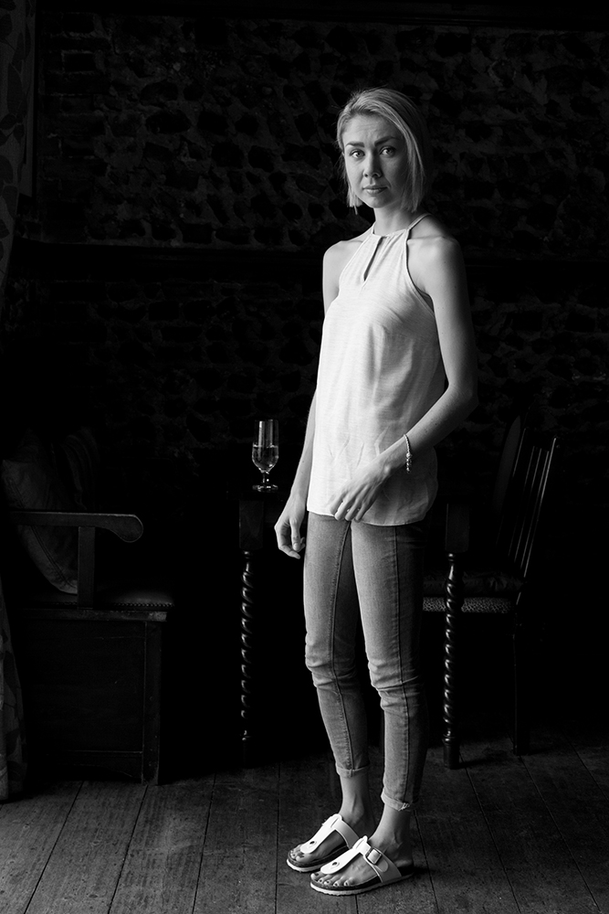 Black and white photograph of a girl in The Red Lion Bar.