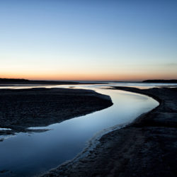 Photograph of incoming tide in the evening on Holkham sands.