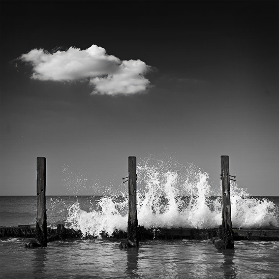 Black and white photograph of breaking seas.