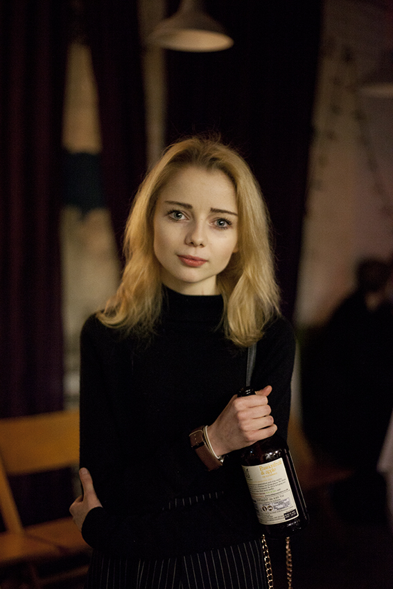 Photograph of girl with a bottle.