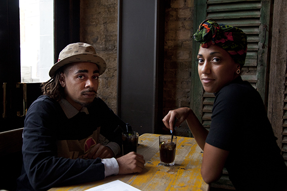 Photograph of two people in a bar.