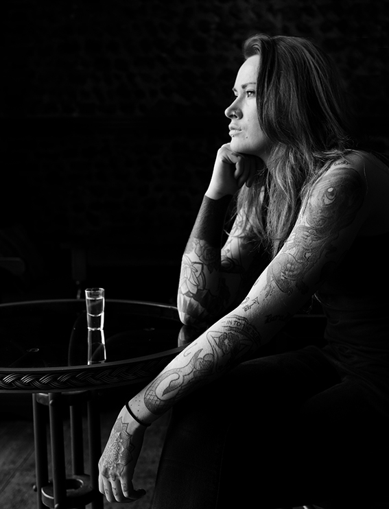 Photograph of tattooed girl in a bar.