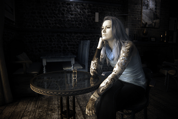 Infrared photograph of a girl with tattoos in a bar