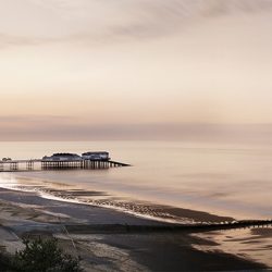 A photograph of Cromer pier and sands at the end of the day.