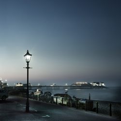 Photograph taken at dusk of Cromer pier and lamplight.