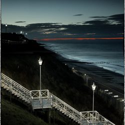 Photograph of steps down to the beach taken at dusk.