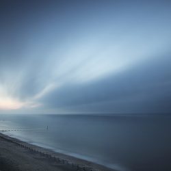 A photograph of the sea towards Sheringham after the sun has gone down.