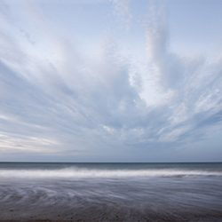 Photograph of the sea below a scudding sky on Cromer beach Norfolk.