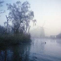 A photograph of the mill at Stalham Norfolk taken in the early morning mist.