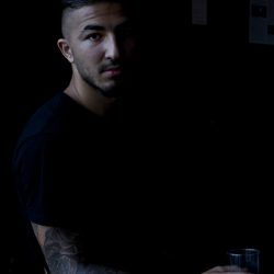 A colour photograph of a young man with a tattoo in The Red Lion bar Cromer