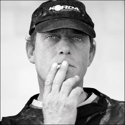 Close up black and white photograph of a tough looking Cromer crab fisherman.