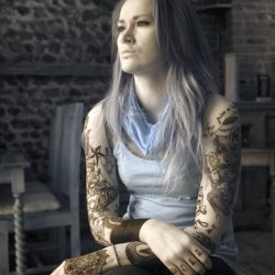 Infrared photograph of a Tattoo Artist with bare arms in a bar.