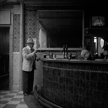 Black and white photograph of a man at the bar of the King Billy pub Hull early 1970's.