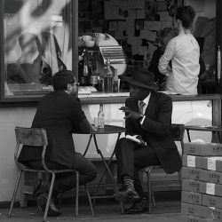 Black and white photograph of a street café.