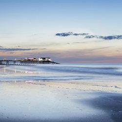 Photograph of cromer sands and pier towards dusk.