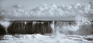 Close up toned photograph of waves crashing ashore in Cromer.