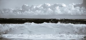 Close up toned photograph of waves crashing ashore in Cromer.