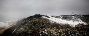 Panoramic of a snow covered Cromer lighthouse.