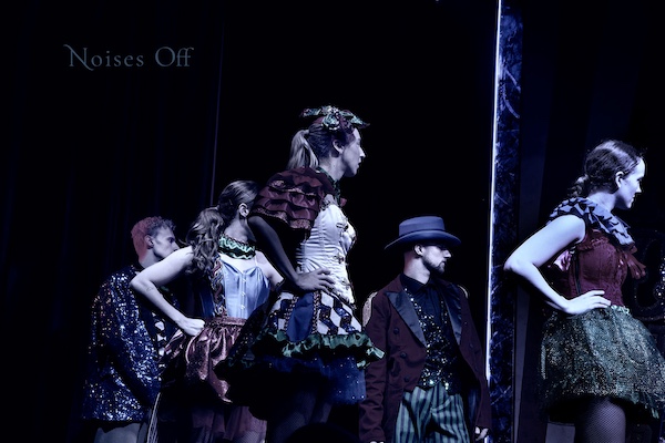 Dancers stare off stage looking surprised, uneasy, concerned. The title perhaps makes sense of something.