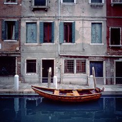 Photograph of a boat in an old part of Venice.