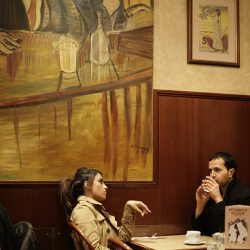 A young couple are talking at a table in Valeries in London.