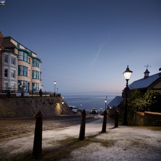 Moody early morning image of Cromer in lamplight and frost from the Gangway