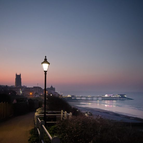 Moody evening image of Cromer in lamplight