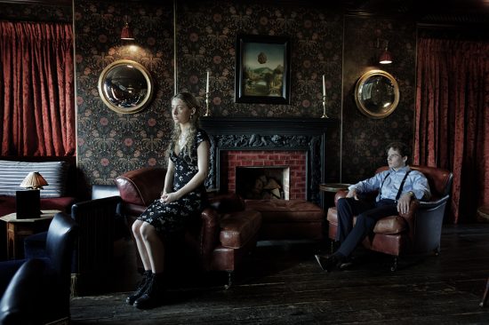 Colour photograph of an enigmatic couple somehow emotionally separated.