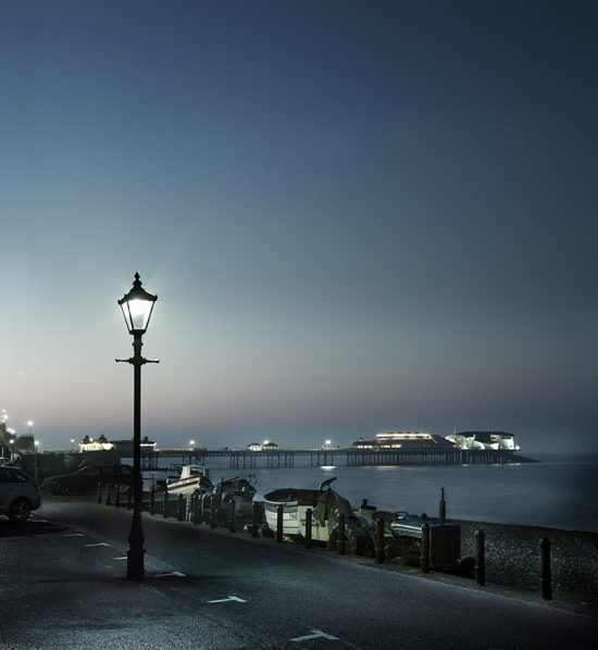 Photograph taken at dusk of Cromer pier and lamplight.