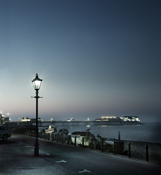 Photograph taken at dusk of Cromer pier and lamplight.