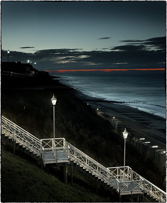 Photograph of steps down to the beach taken at dusk.