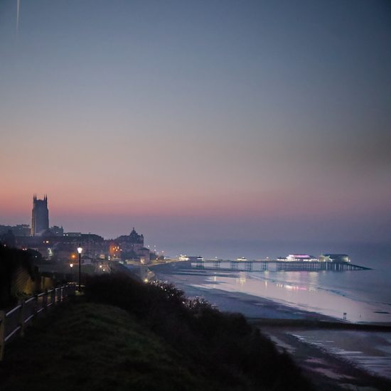 Moody evening photograph with two figures on the sands