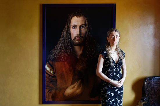 Colour photograph of a girl next to a painting in the Suffield Arms Norfolk
