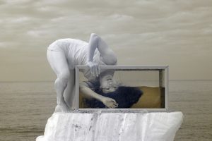 An infrared photograph of the dancer Louise Tanoto dancing into an aquarium on Cromer beach.