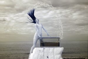 An infrared photograph of the dancer Louise Tanoto dancing into an aquarium on Cromer beach.